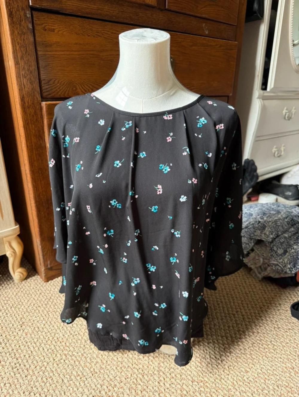 Black floral blouse with sheer sleeves and a flowy fit